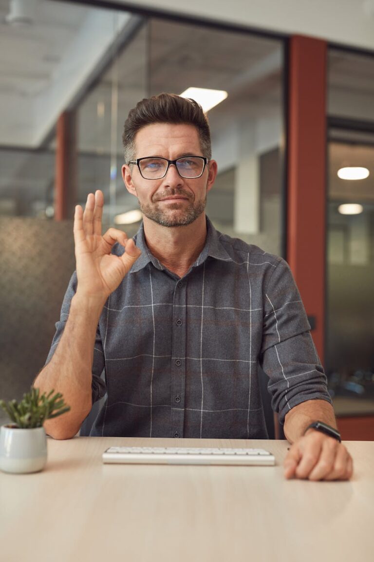 man in gray button up shirt wearing black framed eyeglasses