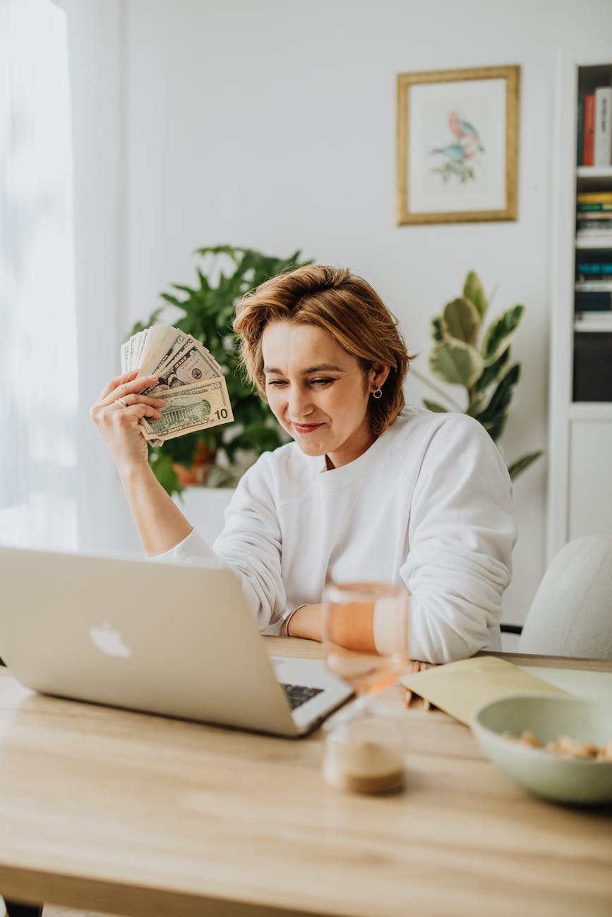a woman holding dollar bills